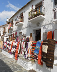 un pasillo estrecho con mesas del restaurante en pampaneira de la alpujarra granadina